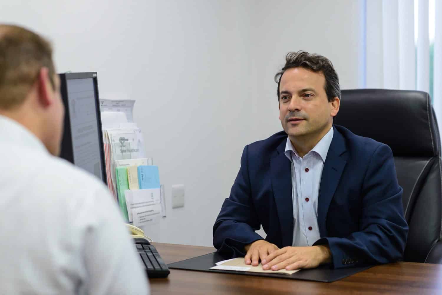 Mr Tim Dudderidge, consultant urologist at The Focal Therapy Clinic, talks to a patient in his office