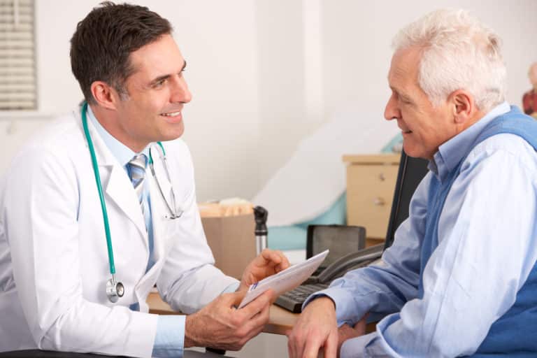 consultant urologist talks to prostate cancer patient